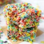 Two cereal treats stacked , made with Fruity Pebbles.