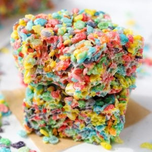 Two cereal treats stacked , made with Fruity Pebbles.