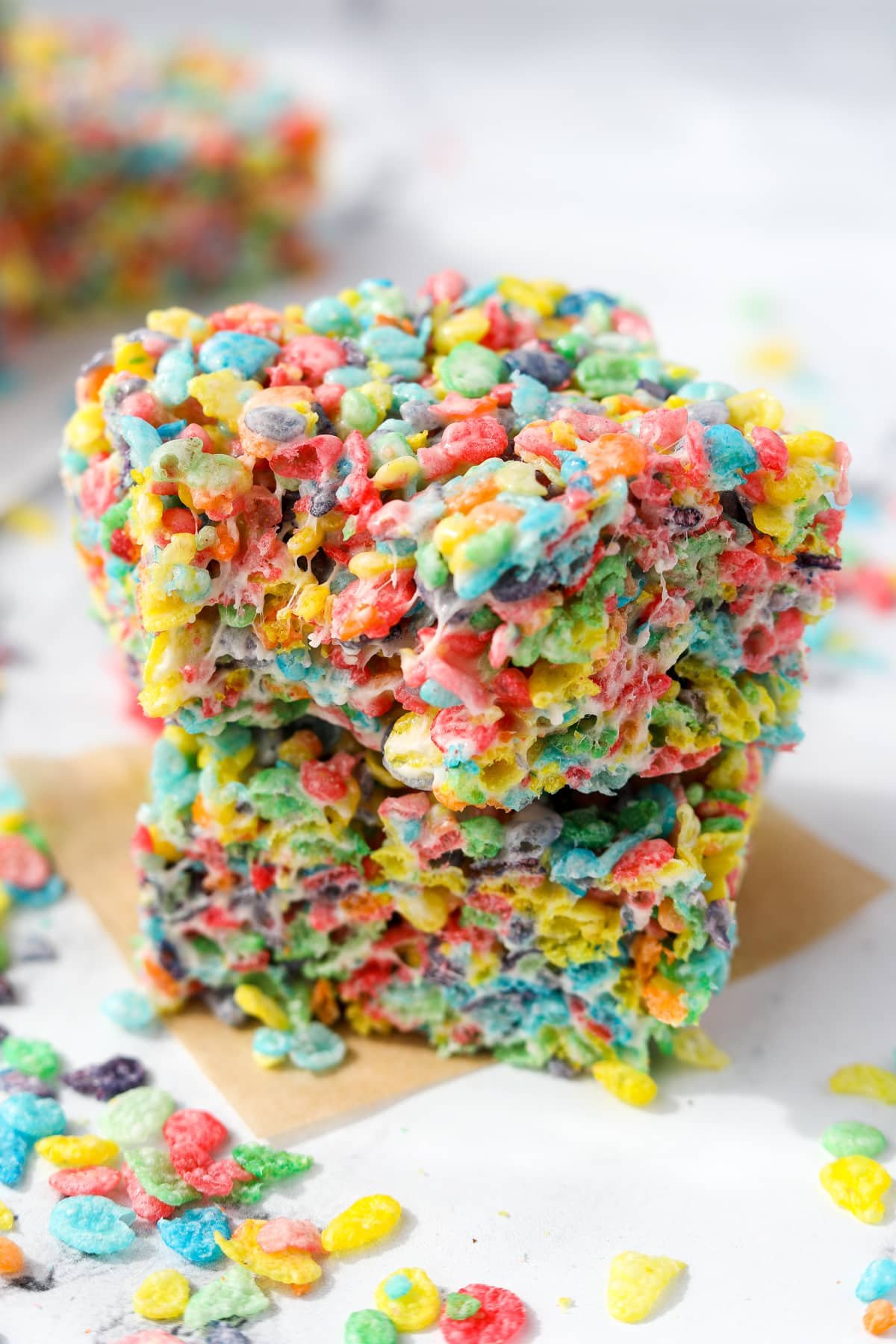 Two squares of Fruity Pebbles cereal treats stacked together.