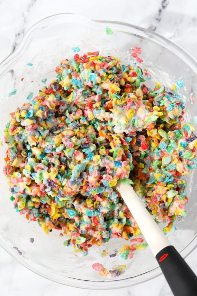 A bowl of fruity pebbles mixed with melted marshmallows.