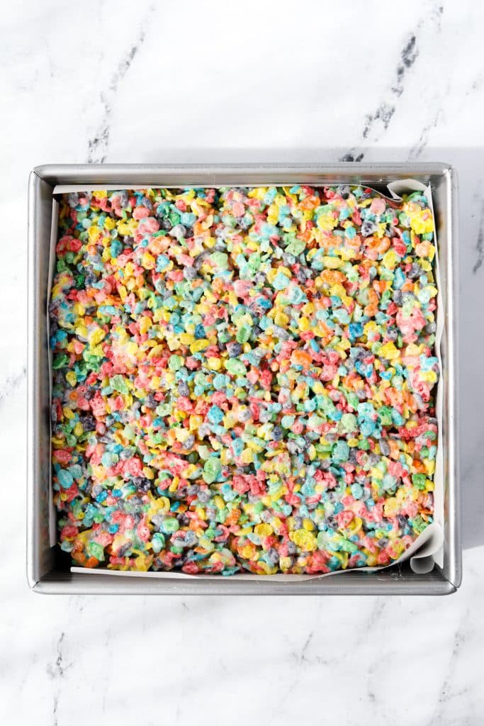A baking pan filled with Fruity Pebbles cereal treats.