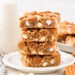 A stack of blondies filled with white chocolate chips.