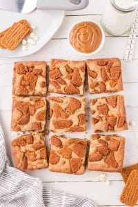 Biscoff blondies cut into squares, topped with biscoff cookies.
