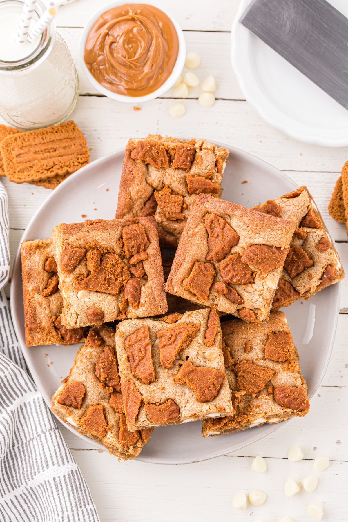 A plate of blondies topped with biscoff cookies.