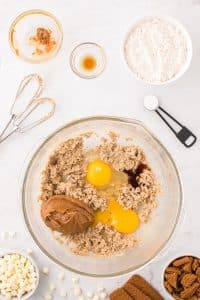 Mixing together creamed butter and sugar with eggs and cookie butter.