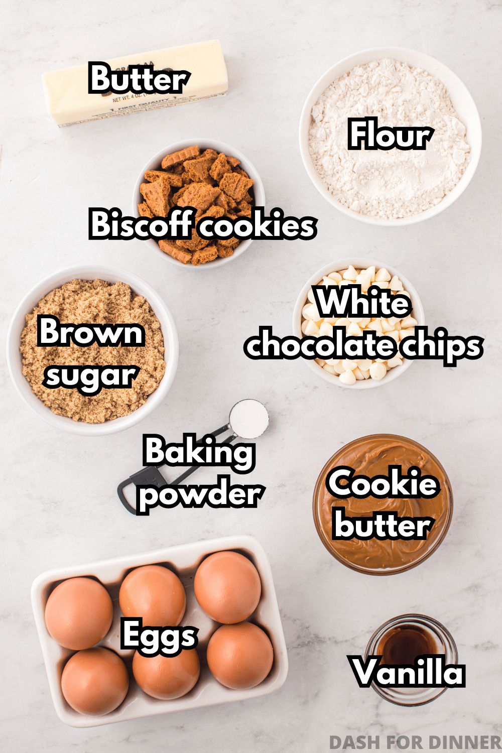 The ingredients needed to make cookie butter blondies: biscoff cookies, eggs, flour, brown sugar, cookie butter, etc.