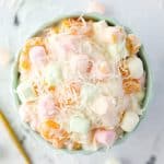 An overhead view of a bowl of marshmallow and fruit salad.