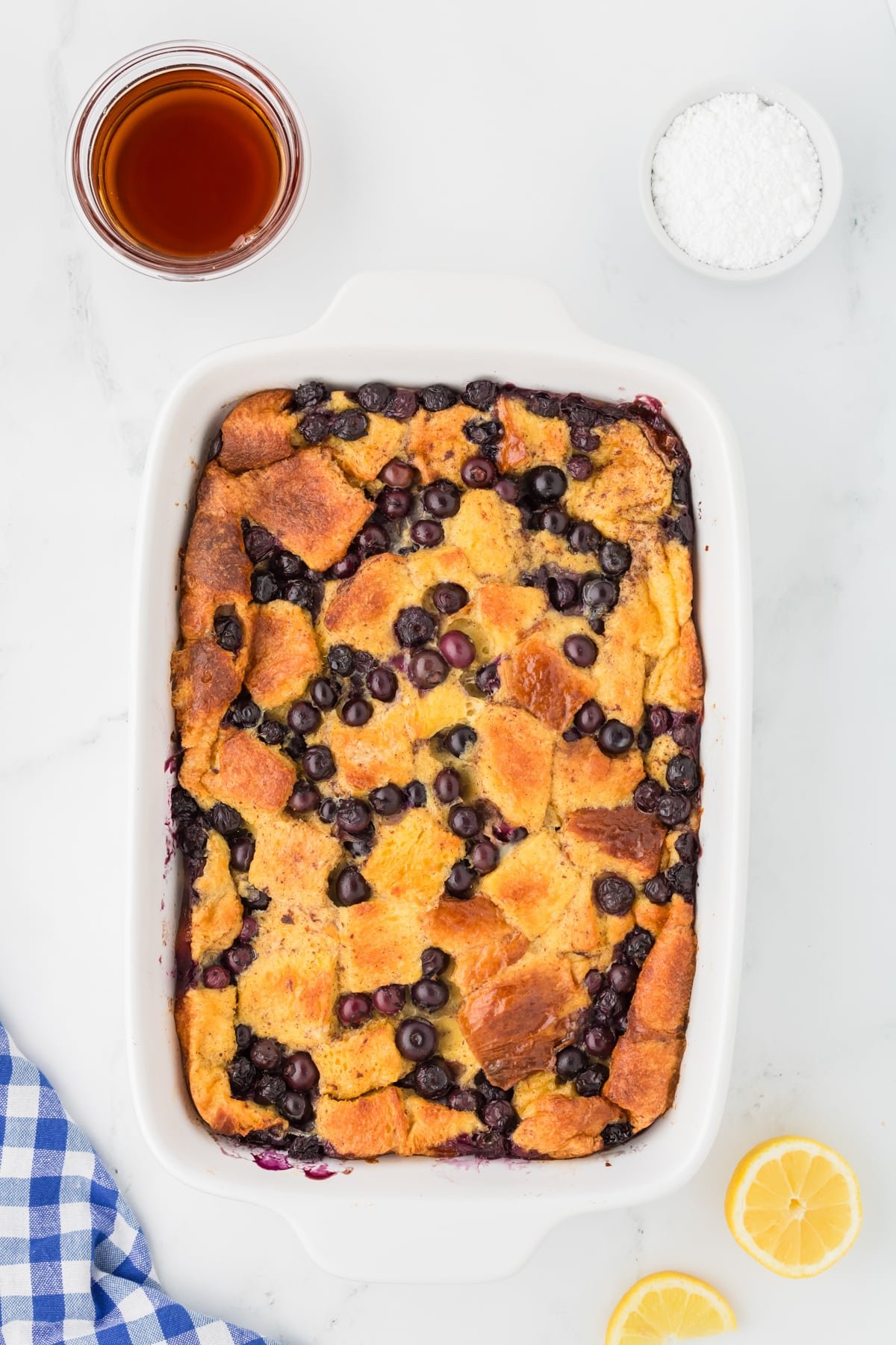 A baking dish with French toast casserole with blueberries.