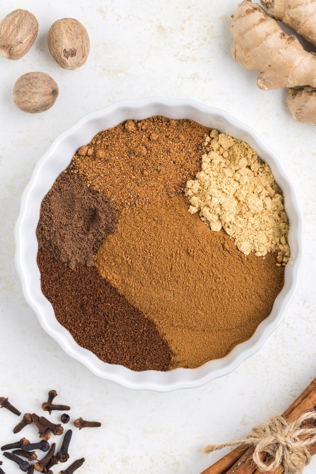 A large rimmed dish with individual spices in a bowl.