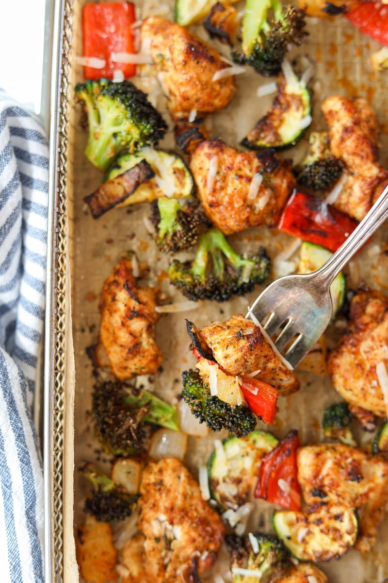 A fork taking a portion of chicken, pepper, and broccoli.