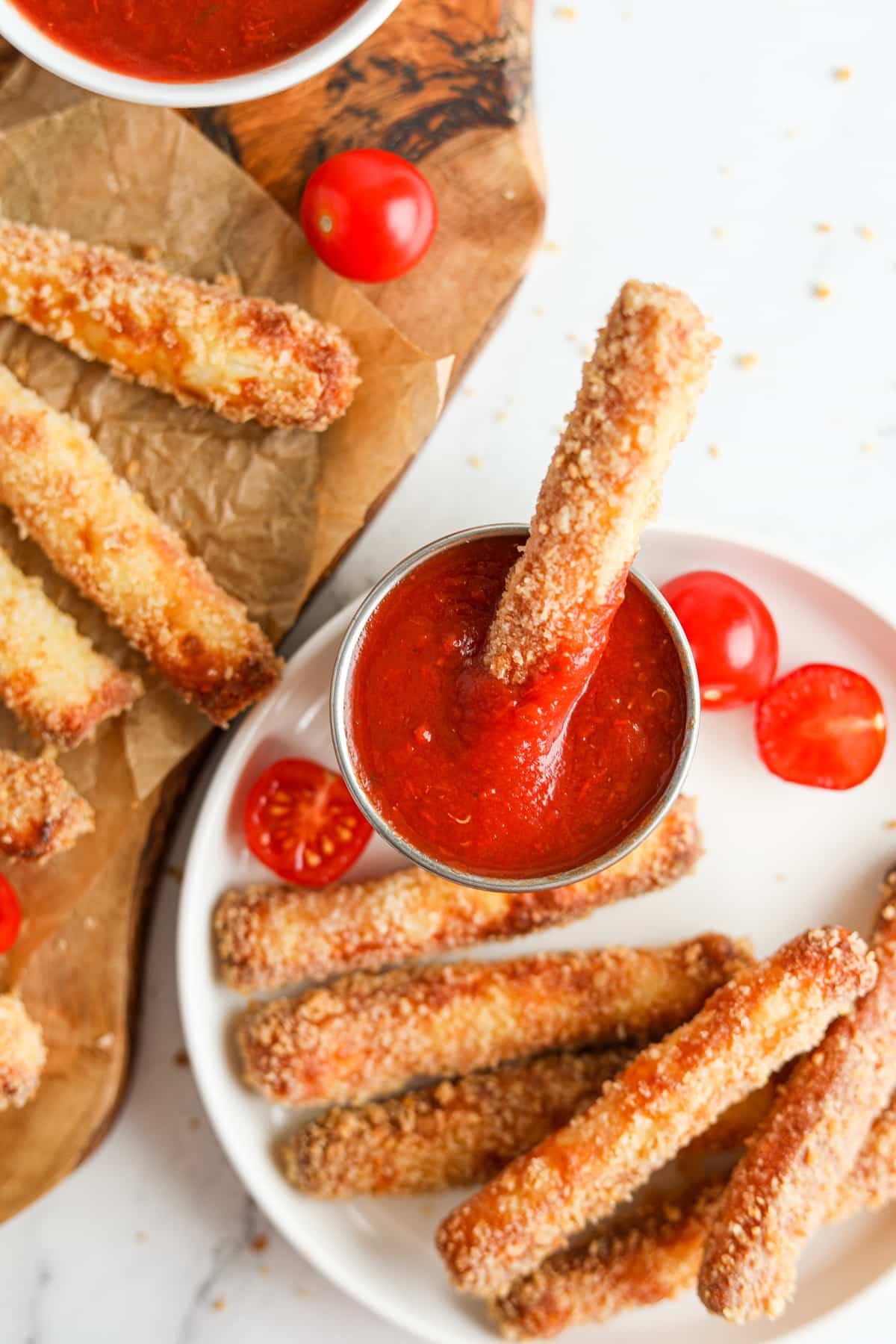 Dipping an air fried cheese fry in pizza sauce.