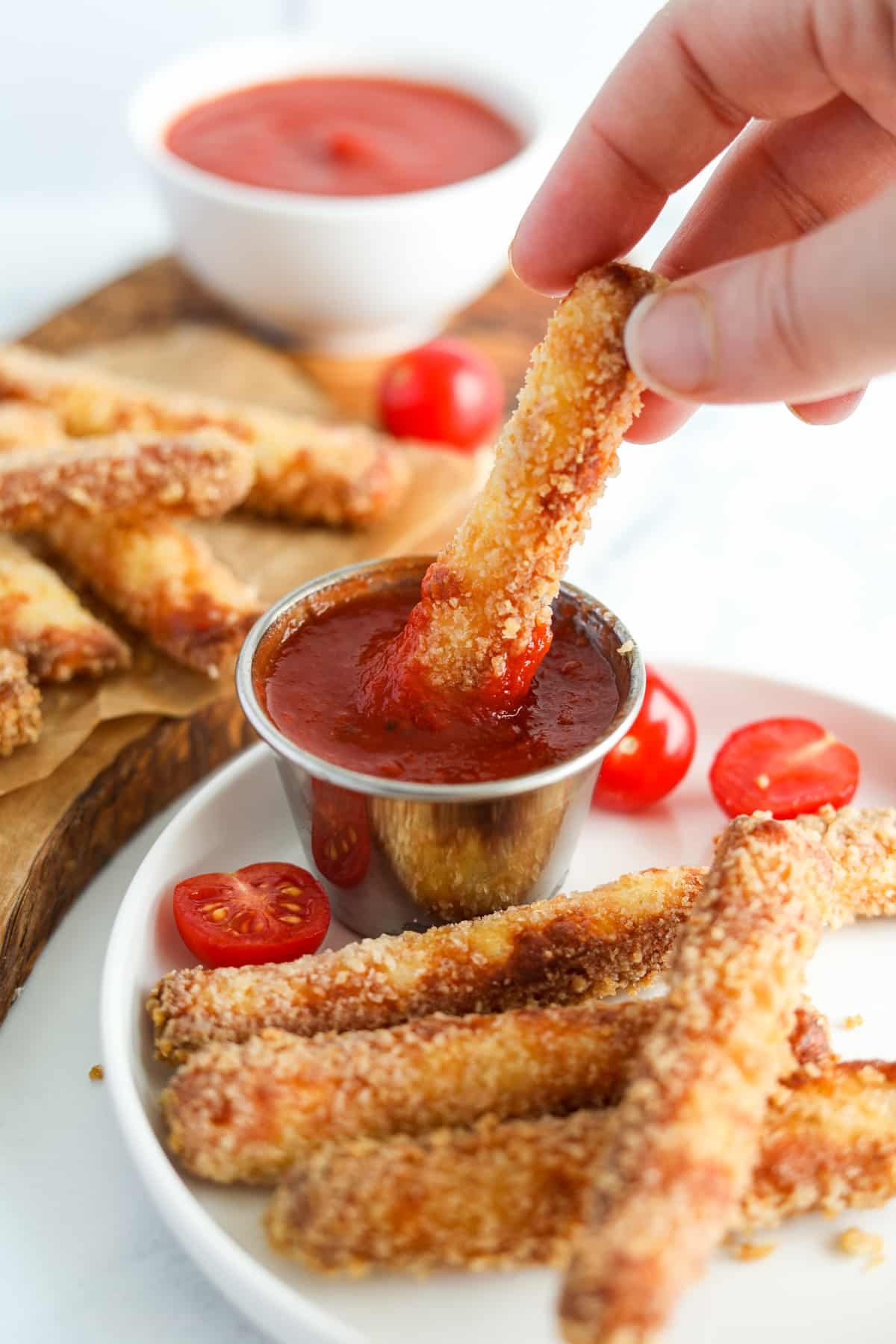 Dipping a halloumi fry into marinara sauce.