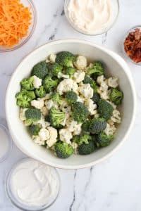 A large bowl with broccoli and cauliflower florets.
