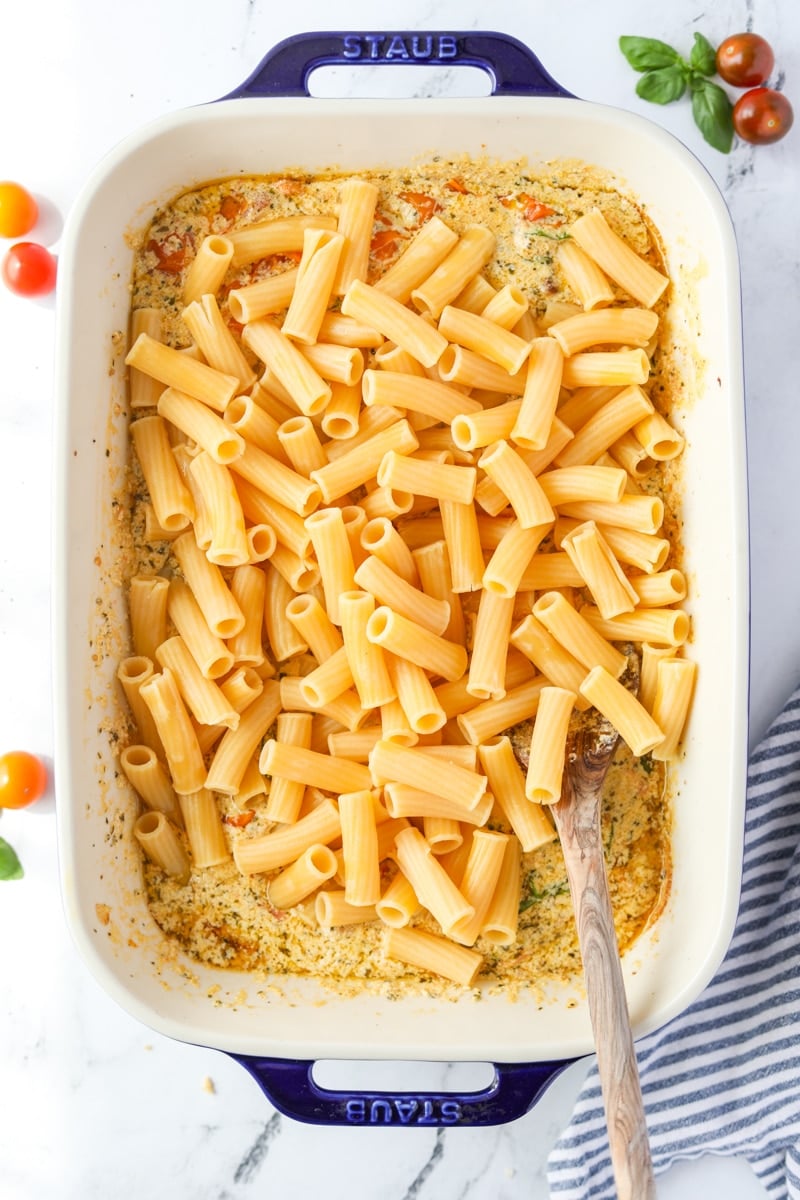 A baking dish with creamy sauce and pasta.