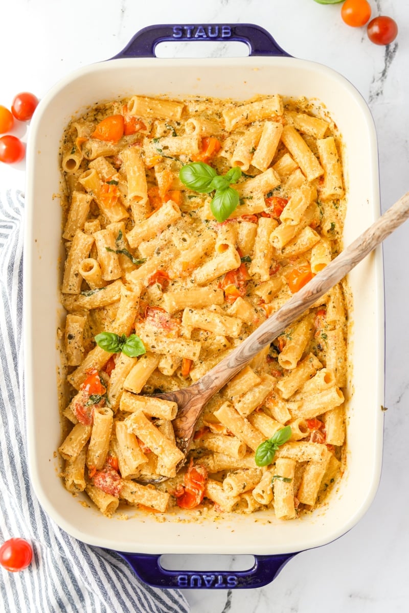 A baking dish with creamy Boursin pasta garnished with basil.