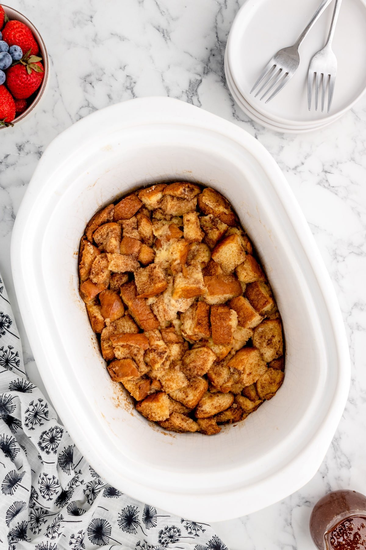 A slow cooker with baked French toast in it.