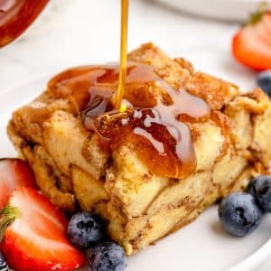A square of French toast drizzled with maple syrup.