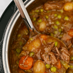 An Instant pot with a ladle inside, scooping out beef stew.