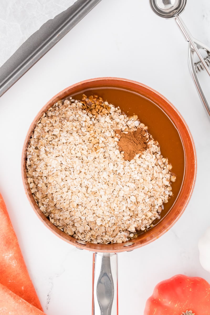 A saucepan with quick oats and pumpkin spice added in.