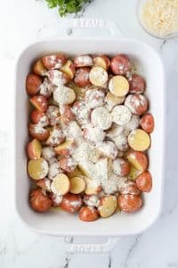 A baking dish with potatoes covered in ranch seasoning.