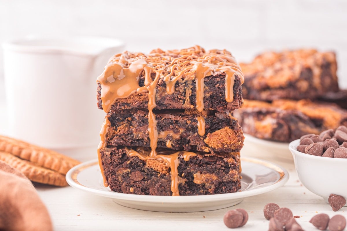 A stack of three brownies, topped with cookie butter.