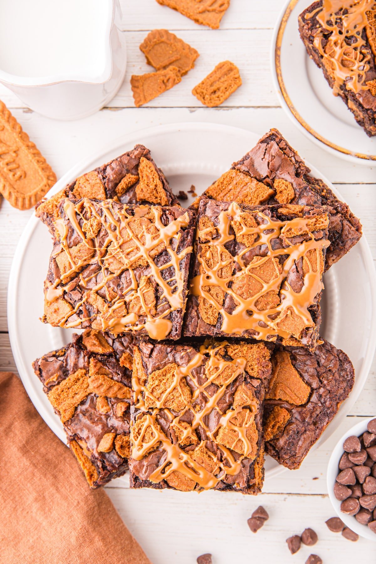 A plate of brownies topped with biscoff cookies and cookie butter.