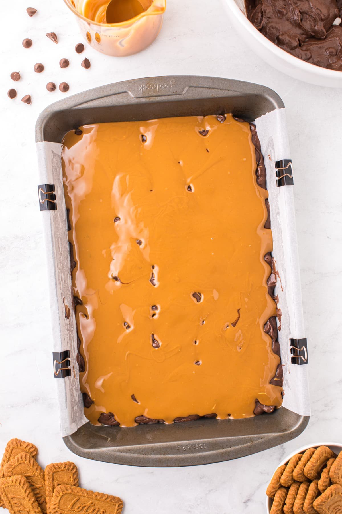 A baking pan filled with brownie batter and topped with cookie butter.