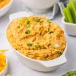 Buffalo chicken dip in an oval baking dish.