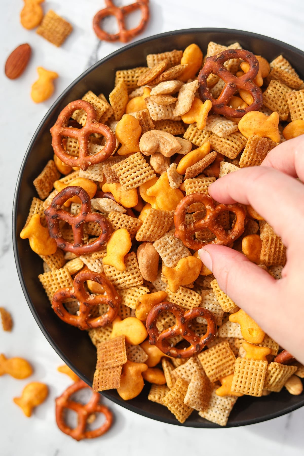 A snack bowl filled with homemade chex mix.