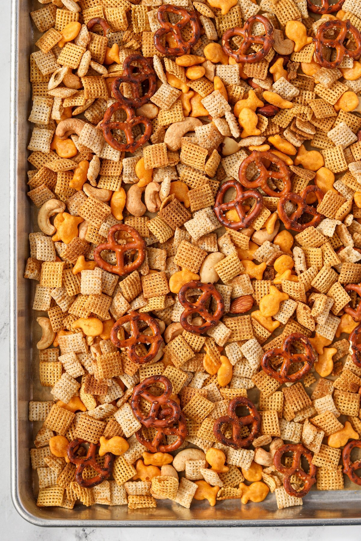 A baking sheet filled with Chex Mix.