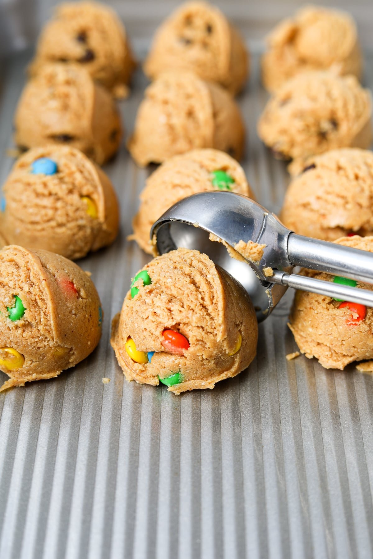 Scooping cookie dough onto a baking sheet.