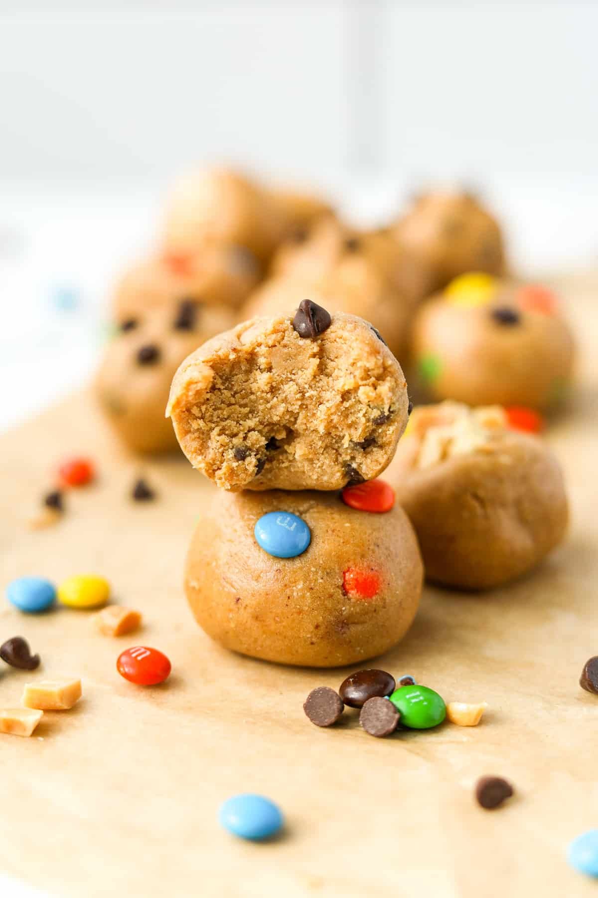 A stack of two protein balls with m&m's and chocolate chips.