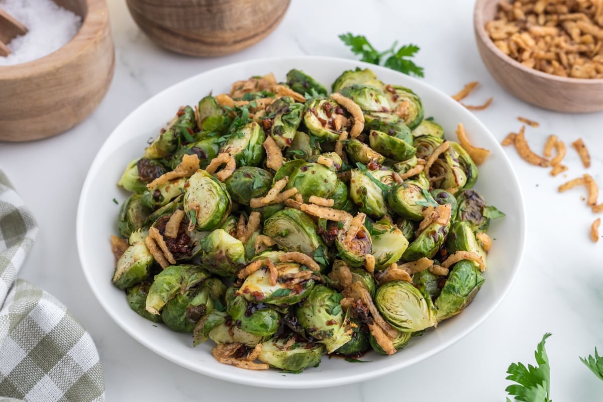 A large serving platter filled with roasted brussels sprouts.