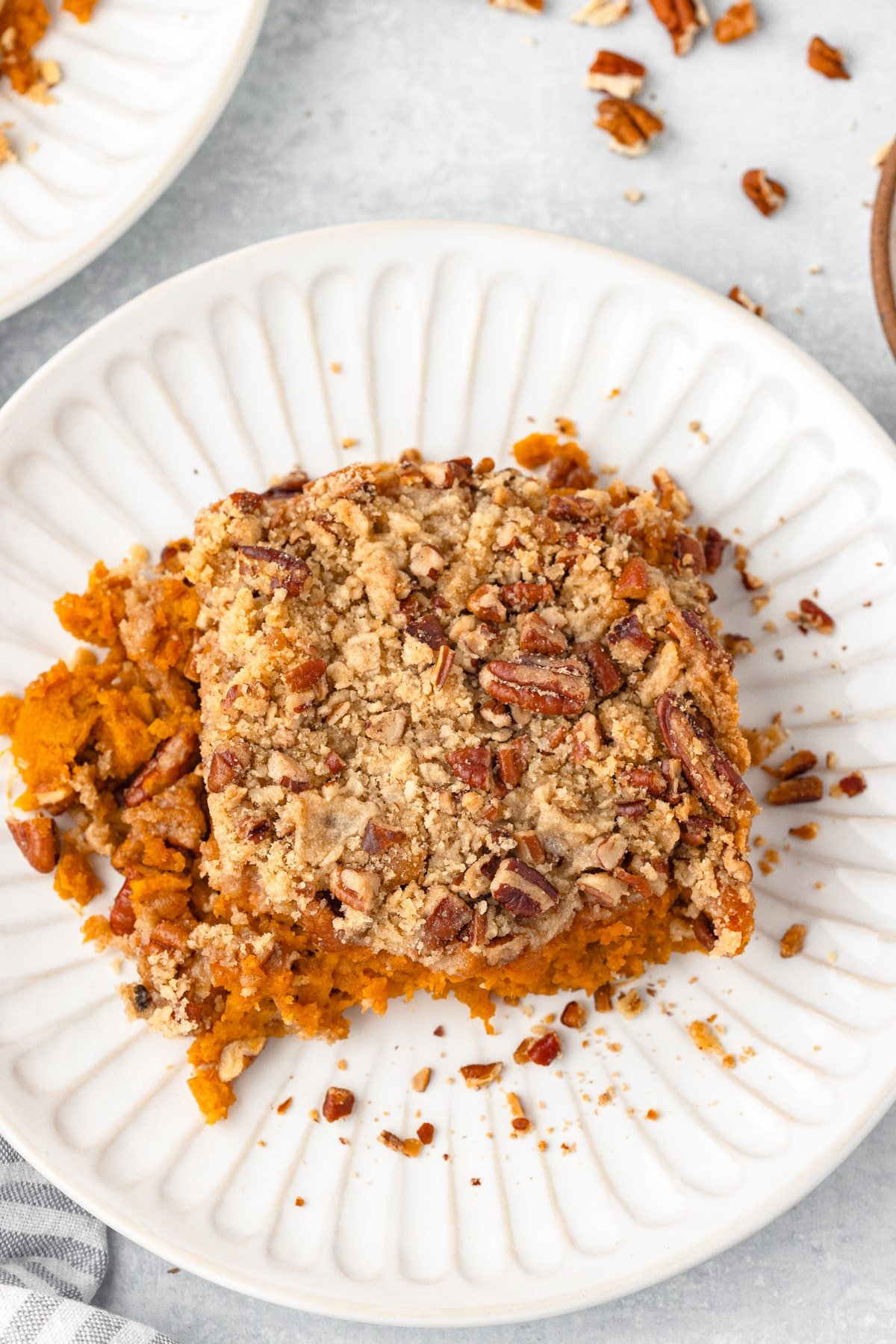 A serving of sweet potato casserole on a white plate.