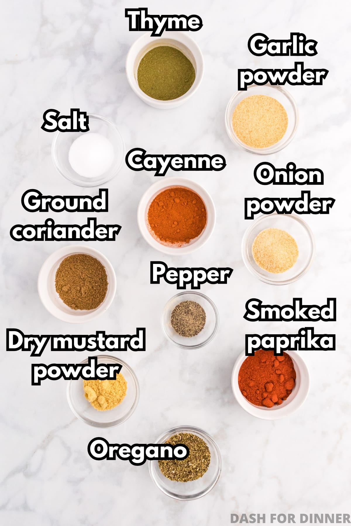 Small bowls of various seasonings, including cayenne, pepper, garlic powder, onion powder, etc.