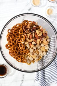 A large bowl filled with pretzels, Chex cereal, and mixed nuts.