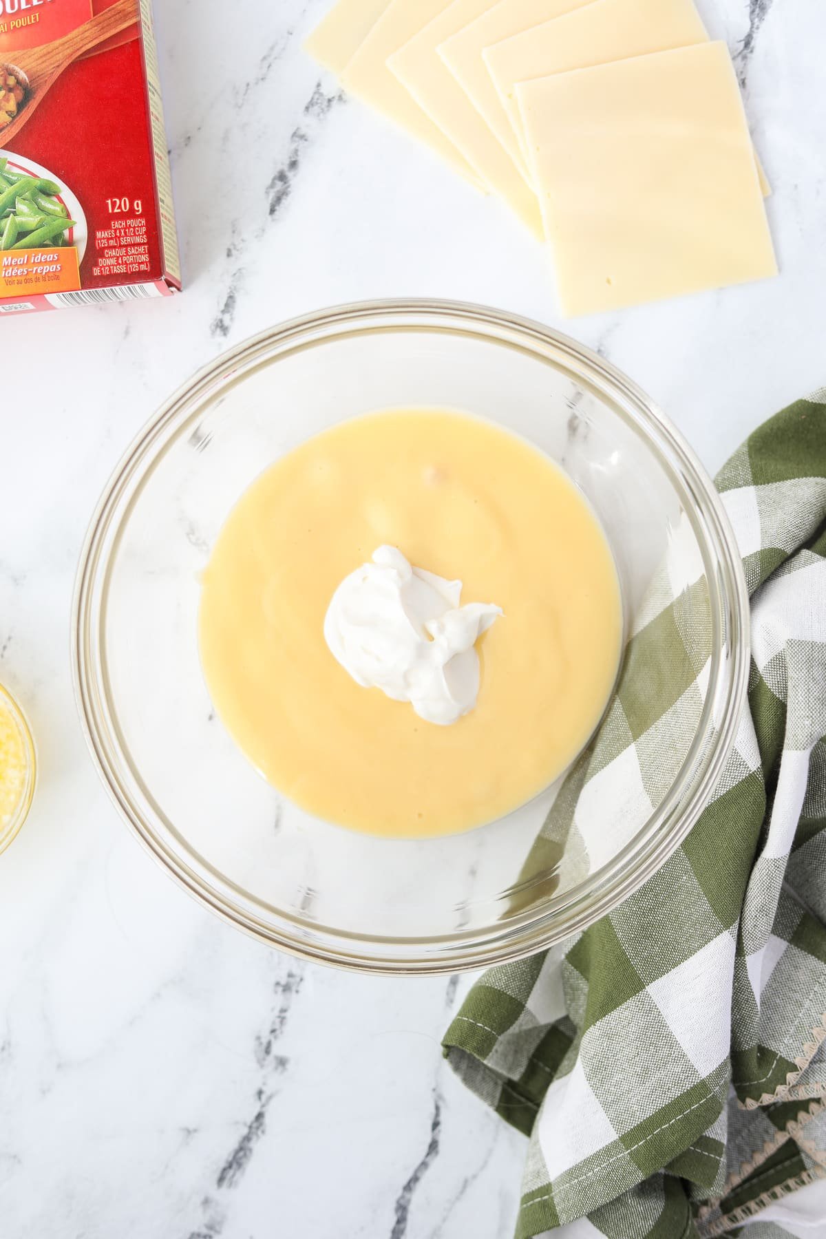 A bowl with cream of chicken soup and sour cream.