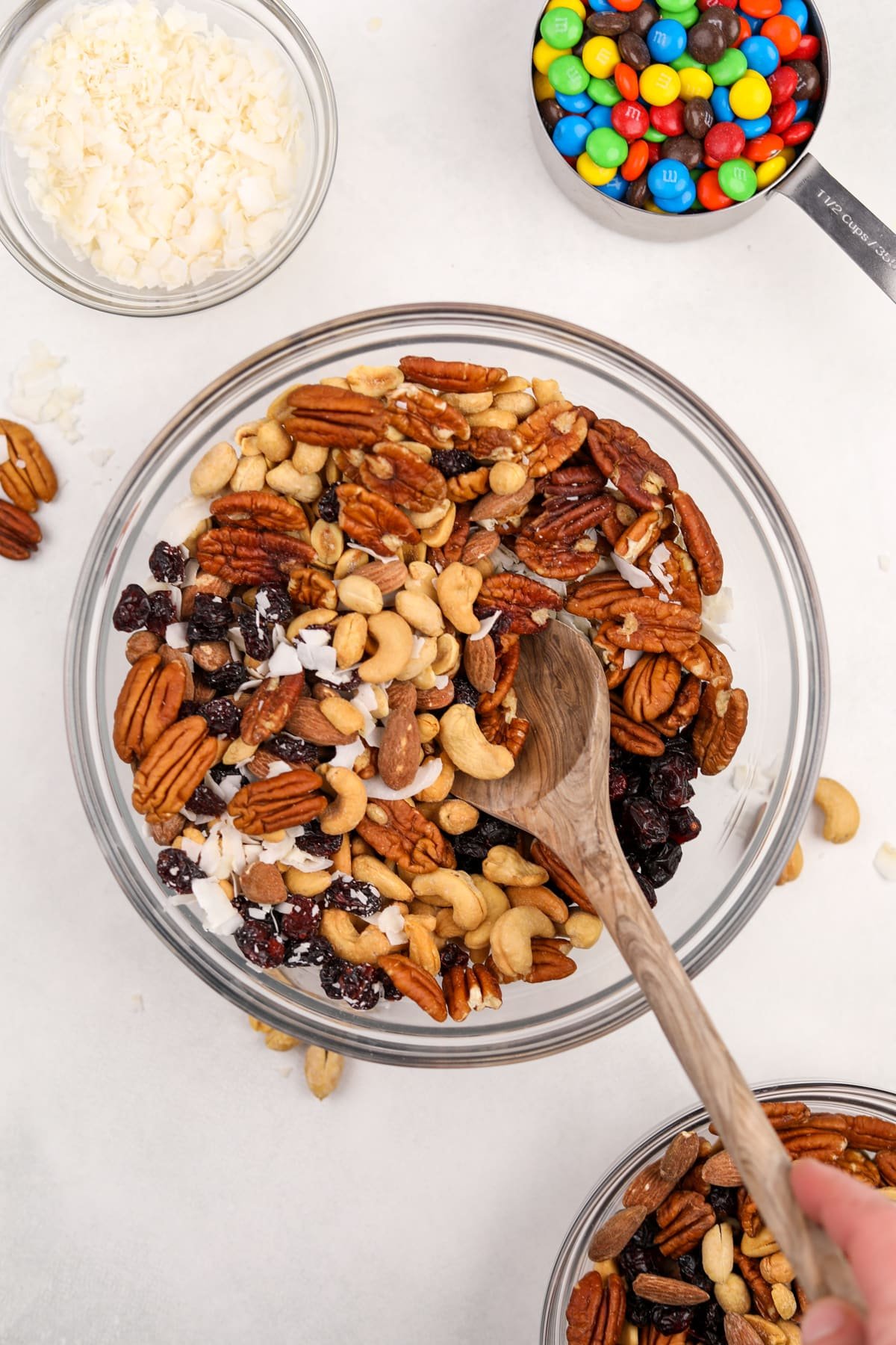 A large bowl filled with mixed nuts, dried fruit, and coconut.