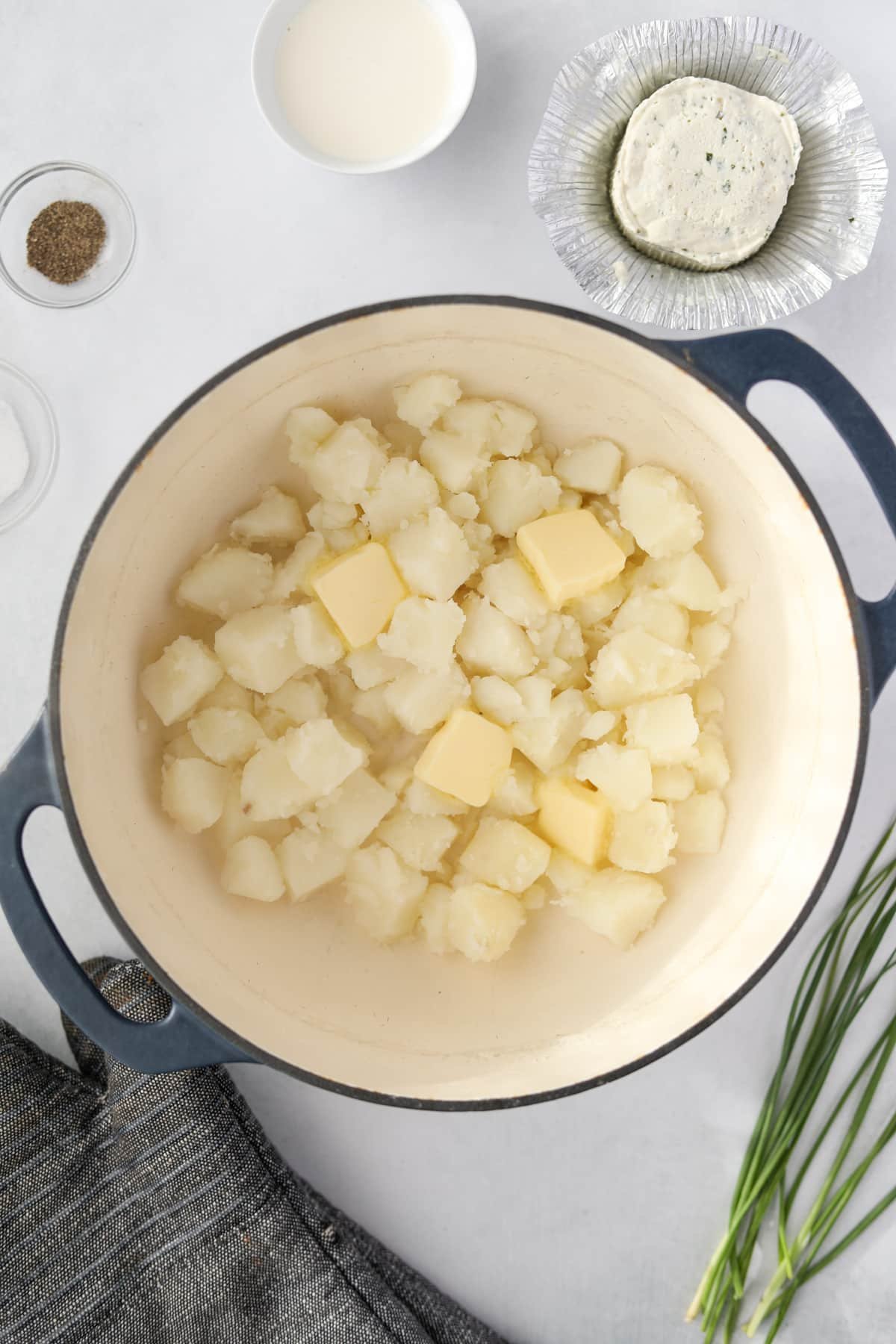 Cooked cubed potatoes with butter in a large pot/
