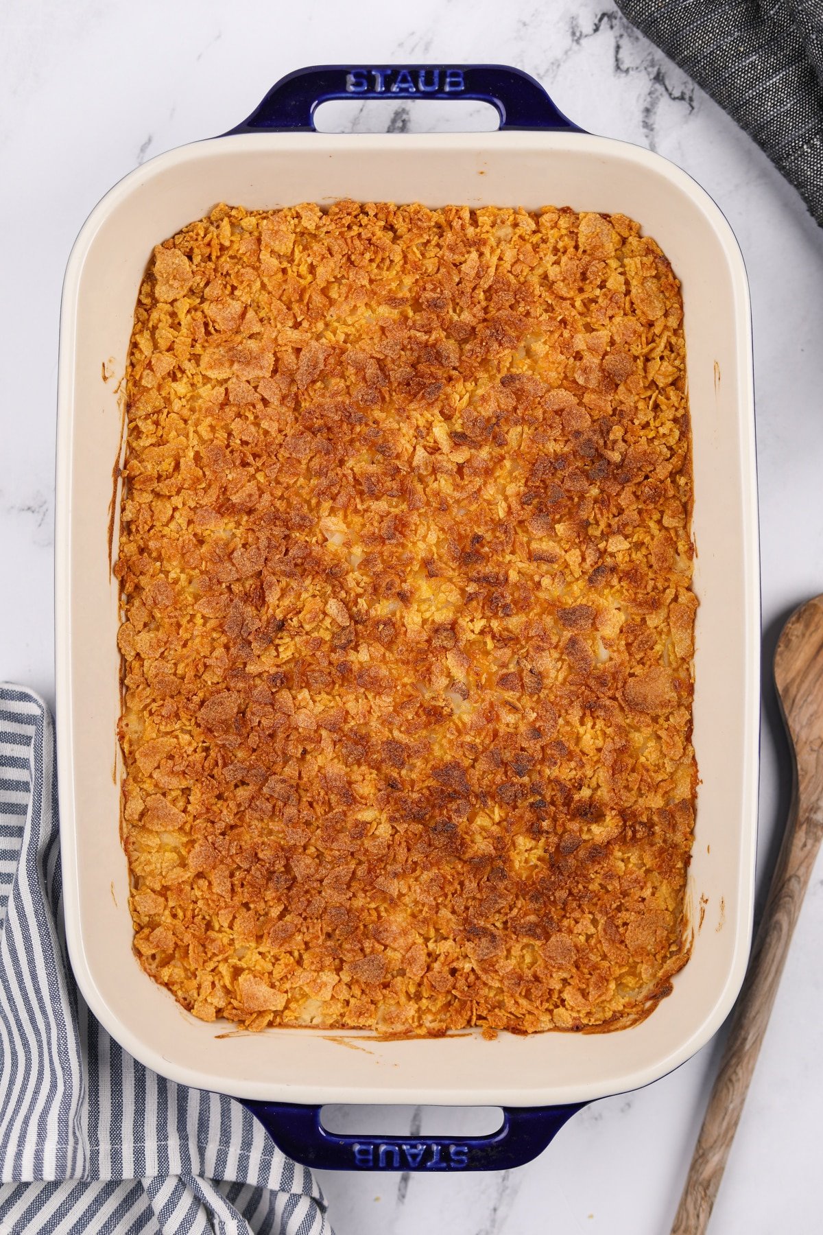 A baking dish filled with a corn flake topped casserole.