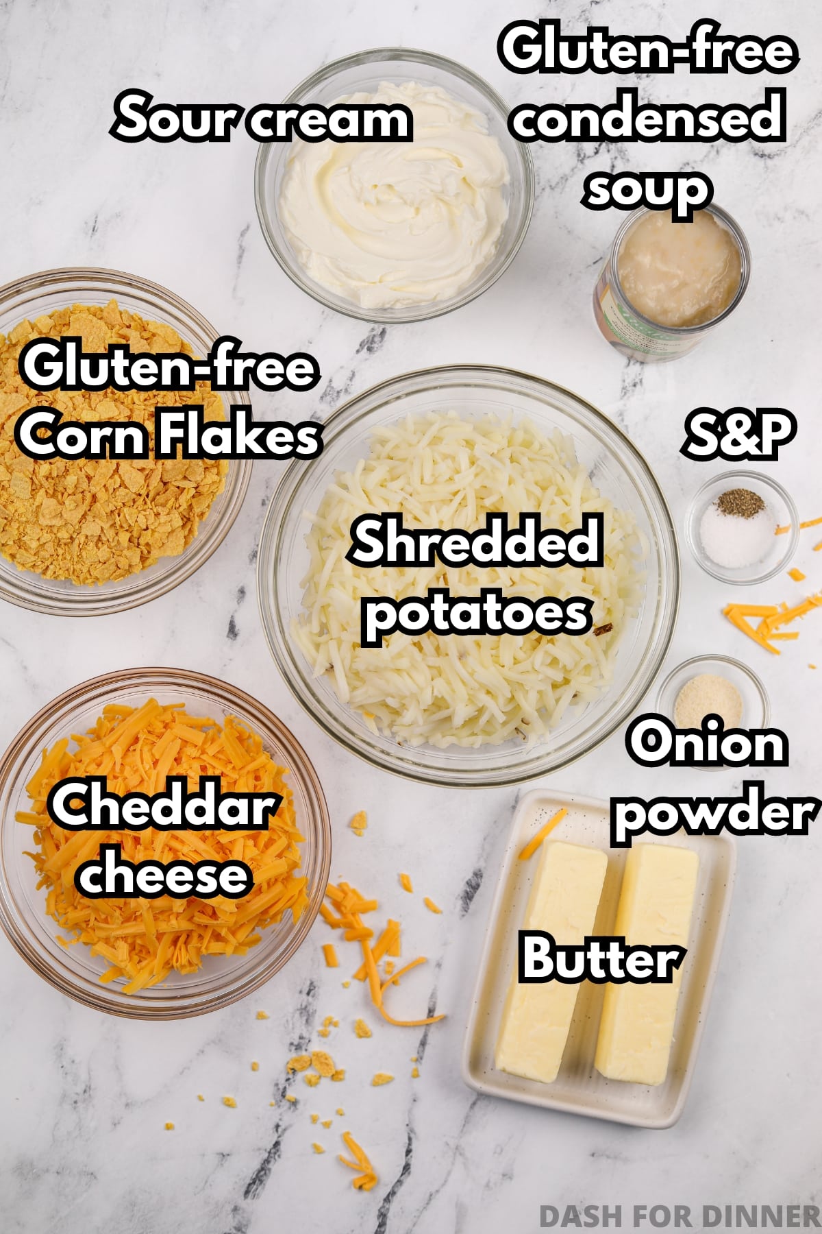 The ingredients needed to make funeral potatoes: shredded potatoes, cheddar cheese, butter, corn flakes, etc.