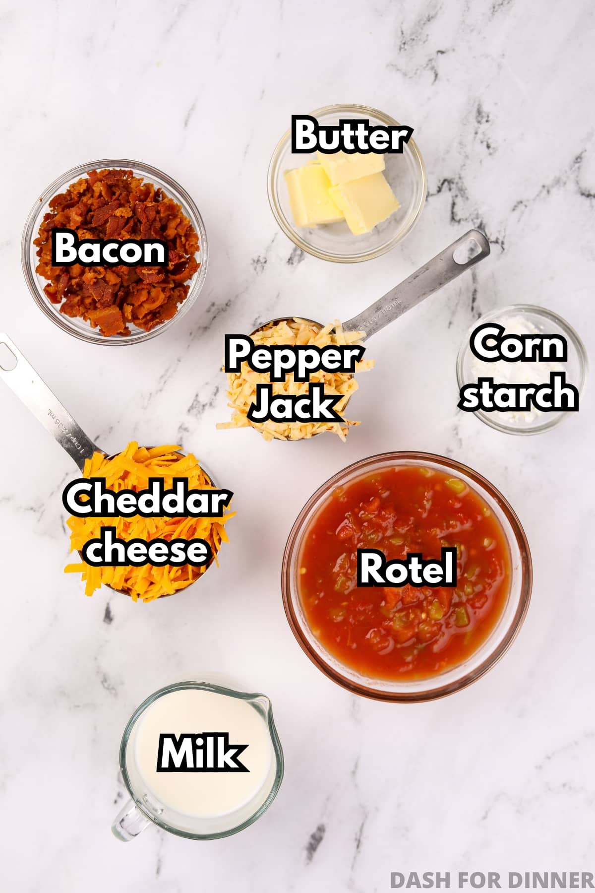 An overhead image of the ingredients needed to make nacho cheese dip: bacon, pepper jack cheese, cheddar cheese, rotel, milk, butter, and cornstarch.