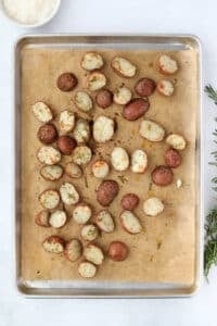 Roasted potatoes on a parchment lined sheet pan.