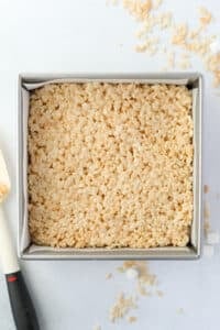 A square baking pan filled with crispy treats.