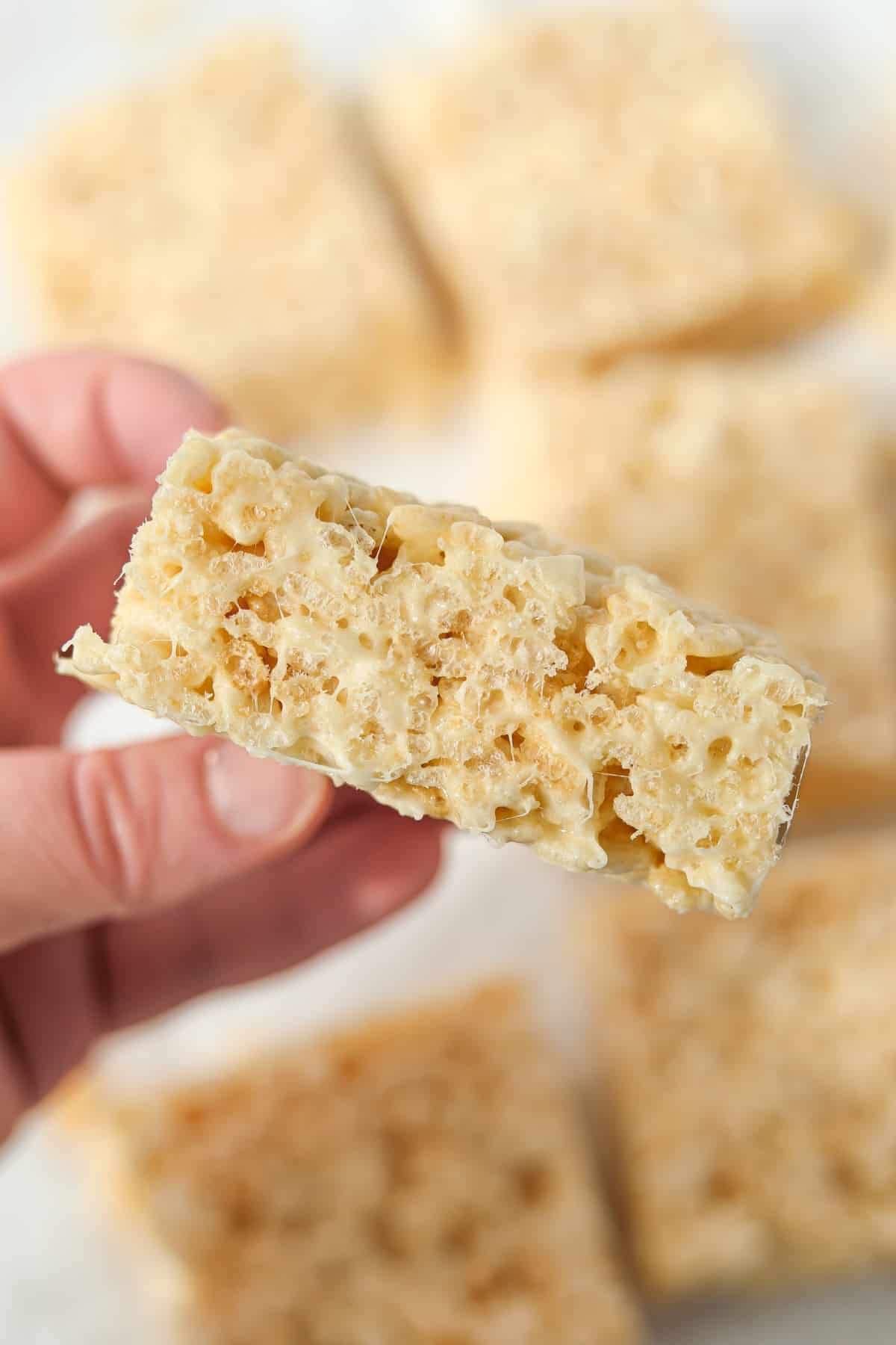 Holding up a rice krispie treat to show the texture.