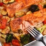 Flaking cooked salmon with a fork.