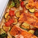 A sheet pan filled with cooked salmon fillets and roasted vegetables. The text box reads: "Sheet pan salmon and veggies"