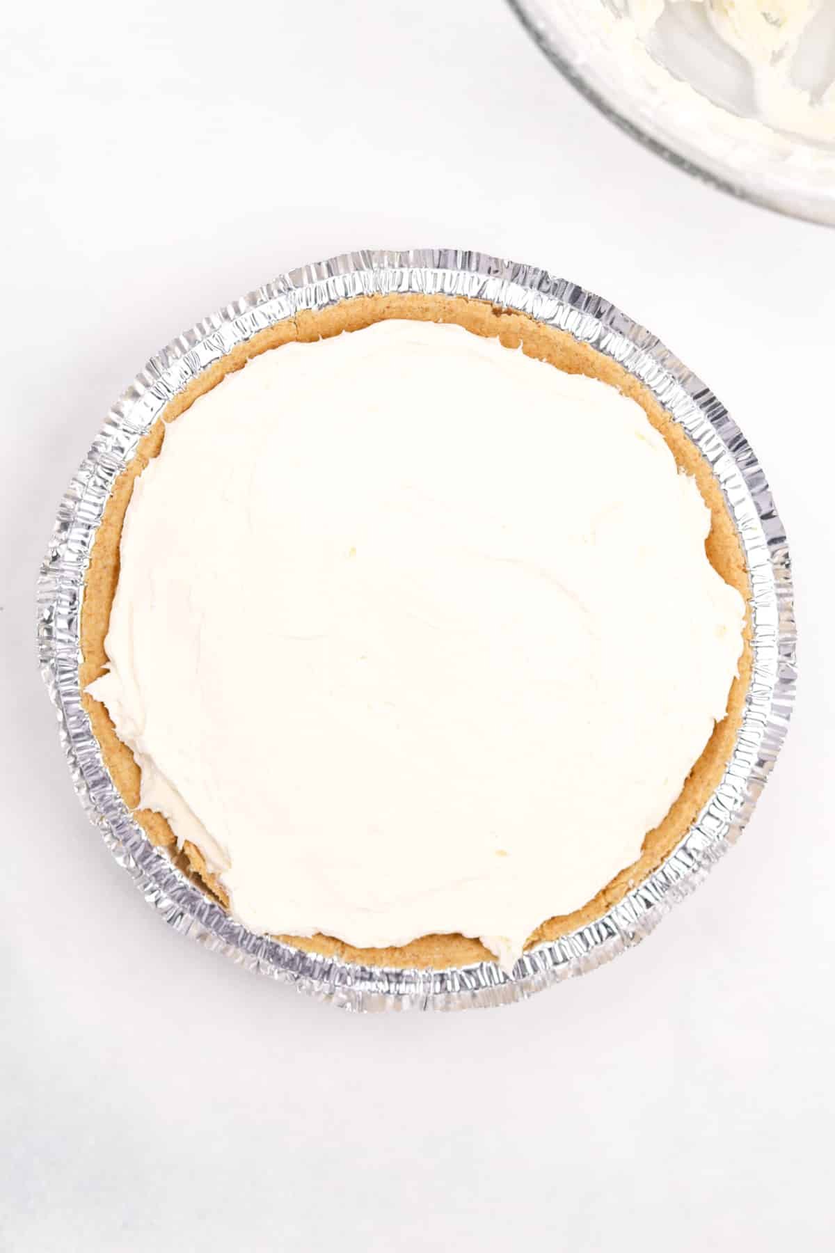 A premade graham cracker crust filled with cheesecake filling.
