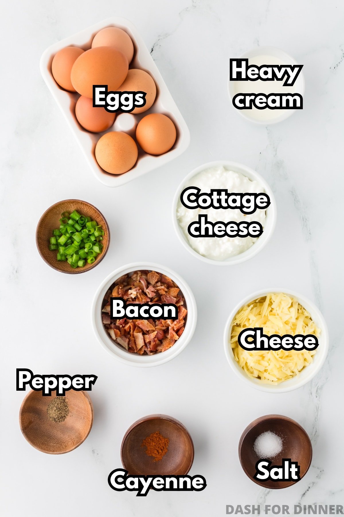 The ingredients needed to make cottage cheese egg bites: eggs, cottage cheese, cheese, bacon, seasonings, and heavy cream.