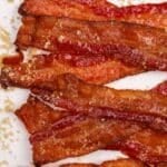Glazed bacon strips topped with brown sugar.